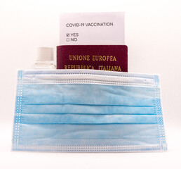 Covid-19 travel kit, including passport, certificate of vaccination, hand sanitizer and a surgical face mask
