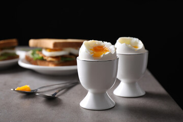 Soft boiled eggs served on grey table. Space for text