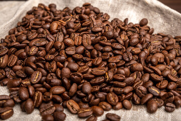 Espresso coffee on a dark wooden background. Coffee preparation, close-up, beans.