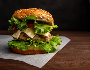 Fresh tasty burger on a blue background. Сheeseburger with chicken cutlet