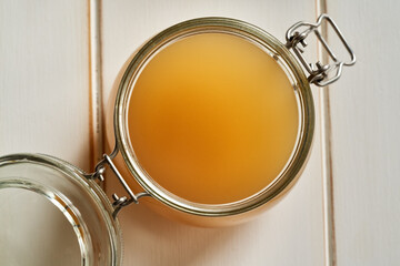 A jar of beef bone broth on a white background, top view