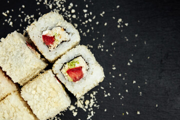 white rolls on black wooden background top view