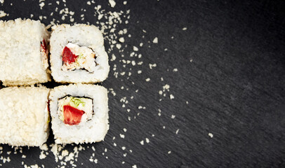 white rolls on black wooden background top view