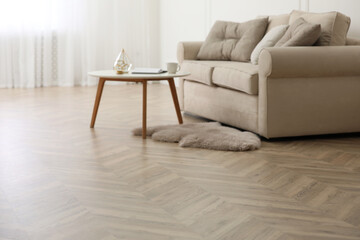 Parquet floor in room with sofa and coffee table