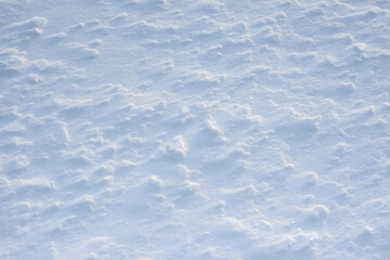 Fresh clean white snow background texture. Winter background with snowflakes and snow mounds. Snow lumps. Seasonal landscape details.