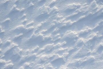 Fresh clean white snow background texture. Winter background with snowflakes and snow mounds. Snow lumps. Seasonal landscape details.