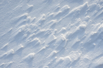 Fototapeta na wymiar Fresh clean white snow background texture. Winter background with snowflakes and snow mounds. Snow lumps. Seasonal landscape details.