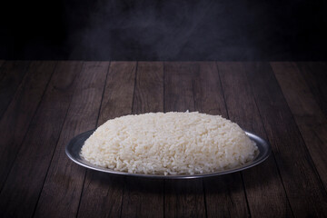 Portion of white rice. Hot food with steam smoke indicating that it has just been made. Gourmet Photography.