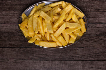 French fries served on a tray. Popular food found in restaurants and snack bars. Lower space for texts and banner creation.