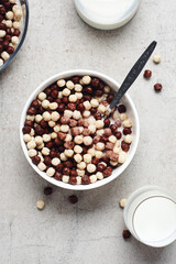Cereal chocolate balls in bowl with milk