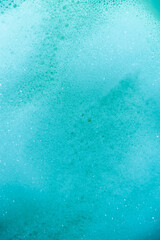 water foam and bubbles of blue color as background. cosmetology concept