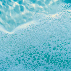 water foam and bubbles of blue color as background. cosmetology concept