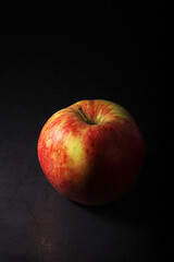 Fototapeta na wymiar An apple against black background 