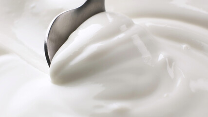 Fototapeta na wymiar Sour cream close up, greek yogurt with spoon