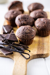 Chocolate muffins. Sweet dark cupcakes with chocolate and vanilla pods.