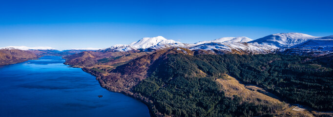 Fototapeta na wymiar an aerial view of loch linnhe and ben nevis near fort william in winter in the argyll region of the highlands of scotland on a clear blue cold day