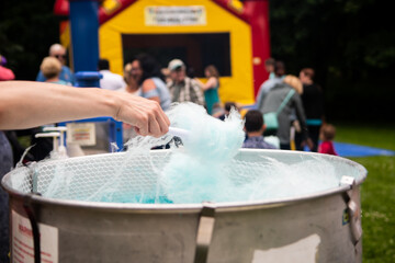 Close up of someone spinning cotton candy in a cotton candy maker