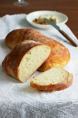 Ciabatta, cheese and nuts on a wooden table.