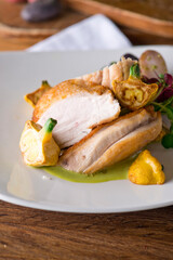 Chicken breast. Chicken pan seared to a crispy golden brown in brown butter and served with fresh organic vegetables: carrots, Brussels sprouts and green beans. Classic American restaurant favorite.