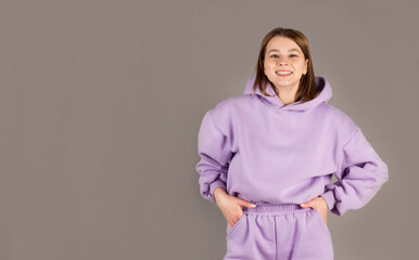 Obraz premium Happy cheerful young woman rejoicing at positive news or birthday gift, looking at camera with joyful and charming smile. Student girl relaxing indoors after college