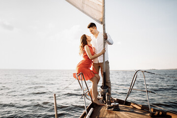 Couple in love on a yacht in the blue sea.