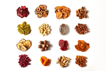 Аssorted dried fruits and nuts on a white background, isolated. Smart food, organic food, keto diet. Cashews, Brazil nuts, walnuts, macadamia, almonds, slices of dried kiwi, plum, strawberry, pear.