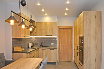 Kitchen room with lighting. Modern minimalism with loft elements
