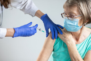 elderly woman getting coronavirus vaccine