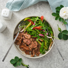 Roasted beef with fresh vegetables and herbs salad.