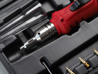 red gas soldering iron in black plastic box