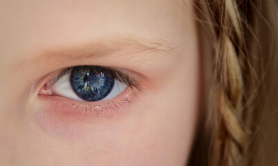 Child's blue eye look close up. Little kid girl watching  at the camera. Childhood and kids protection, memories concept.
