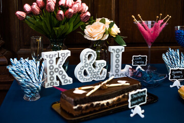 dessert Table at a Party or wedding with lost of blue and pink colors and wooden wall