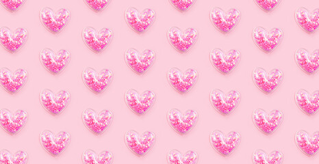Many hearts with glitter on pastel pink background. Love pattern. Valentines day, birthday holiday decor