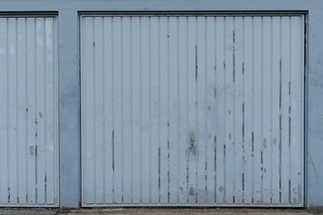 Blue garge door closed and empty, no people and space for text