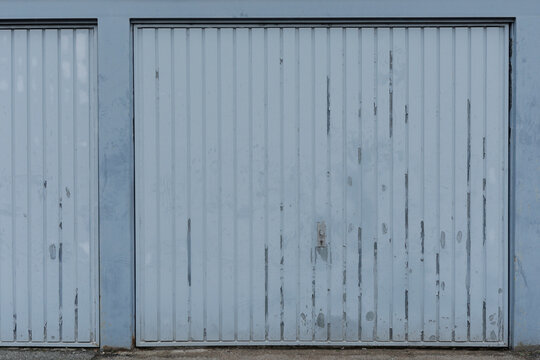 Blue garge door closed and empty, no people and space for text