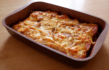 baked meat with cheese in a ceramic mold