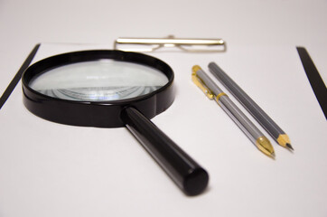 white sheet magnifier pen lies on a white background