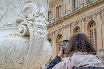 Taking a photo of a sculpture in the Gardens of the Palace of Versailles - historical, royal.