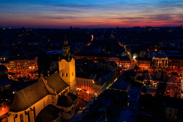 Aerial night view of illuminated Latin cathedral and Rynok square in Lviv, Ukraine. View from Lviv town hall