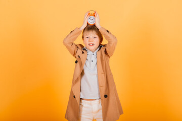 Worried awake teen boy with alarm clock is shocked because it is too late