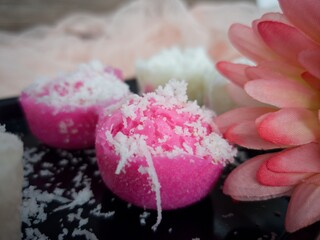 Fluffy and delicious steamed rice cake or locally known as apam beras or apam nasi with grated coconut on top. Selective focus points. Blurred background
