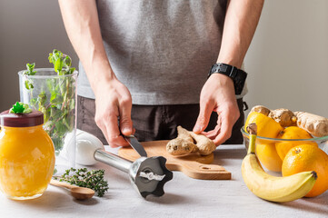 Preparation for slicing ginger. Slicing ginger root for a cocktail.