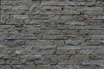 Brick stone wall with cracked and uneven background, space for text, no people and horizontal