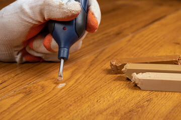 restoration and repair of laminate and parquet with wax.