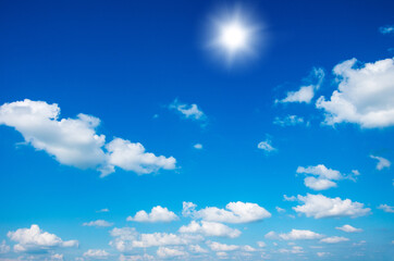 Blue sky with clouds and sun.