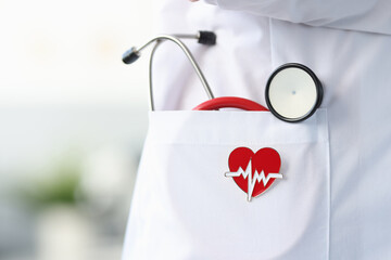 Stethoscope and heart icon lie in white doctor's coat