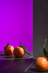 three tangerines with leaves