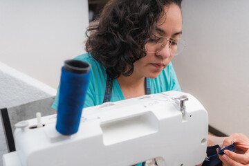 Young woman at her sewing machine