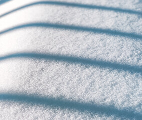 Winter snow texture.
Texture, background of winter snow with geometric abstract shadow, side view close-up.