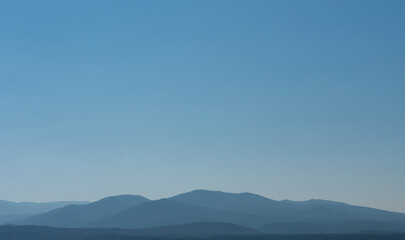 Hazy Distant Mountains Against a Clear Blue SKy